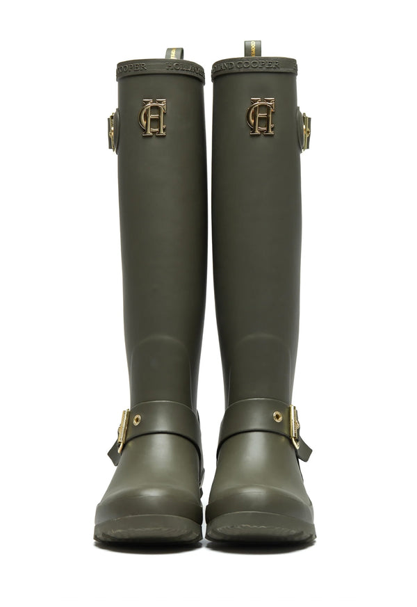 Pair of green rubber boots with buckles on a white background