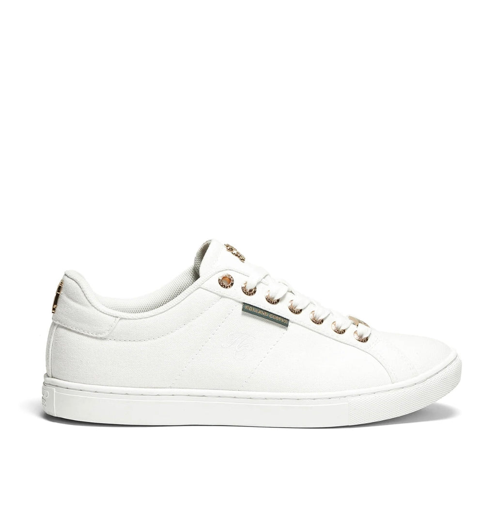 White sneaker with gold accents on a white background