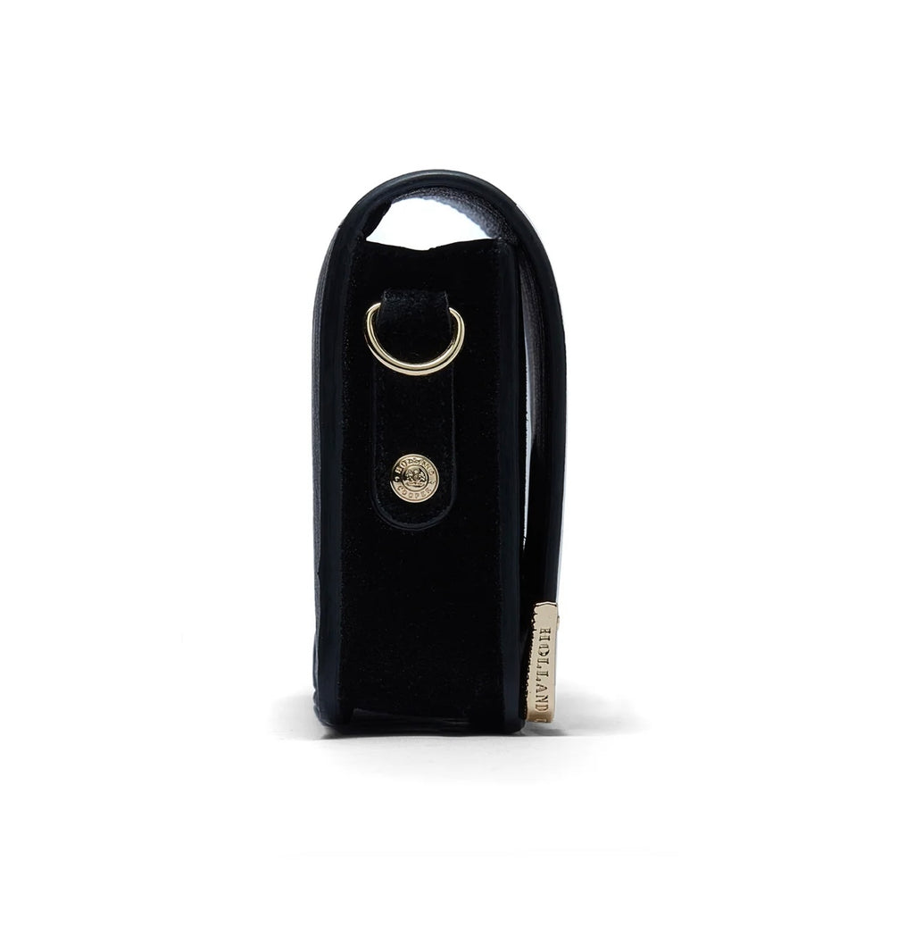 Black leather key case with gold accents on a white background