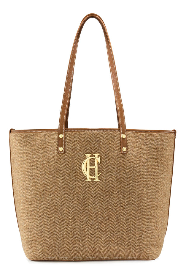 Beige tote bag with a gold logo on a white background