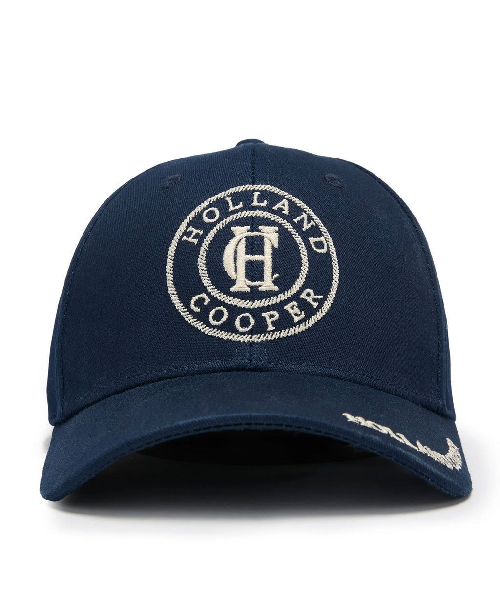 Navy blue cap with 'Holland Cooper' logo on a white background