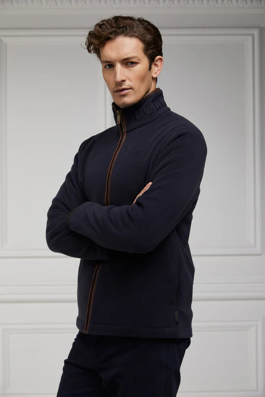 Man wearing a navy blue fleece jacket with a white background