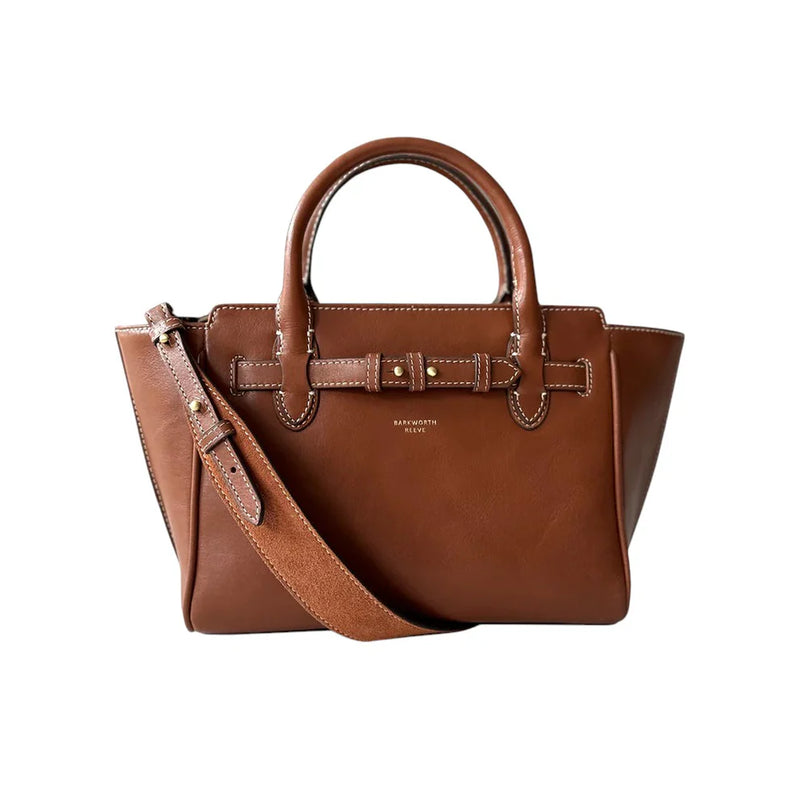 Brown leather handbag with a strap on a white background