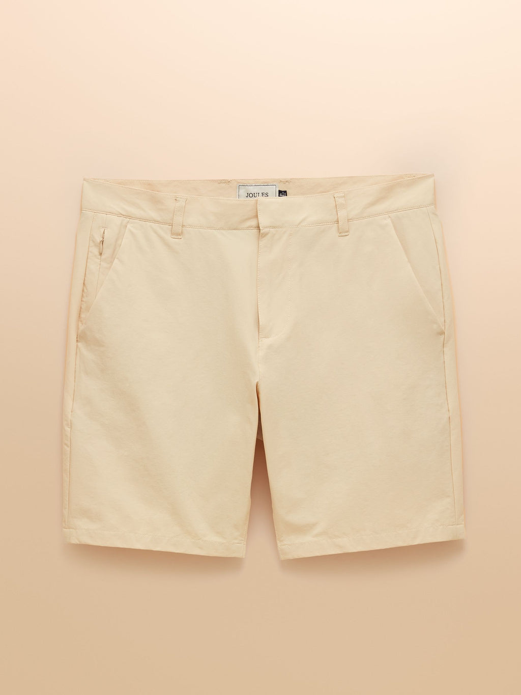 Beige shorts on a peach background
