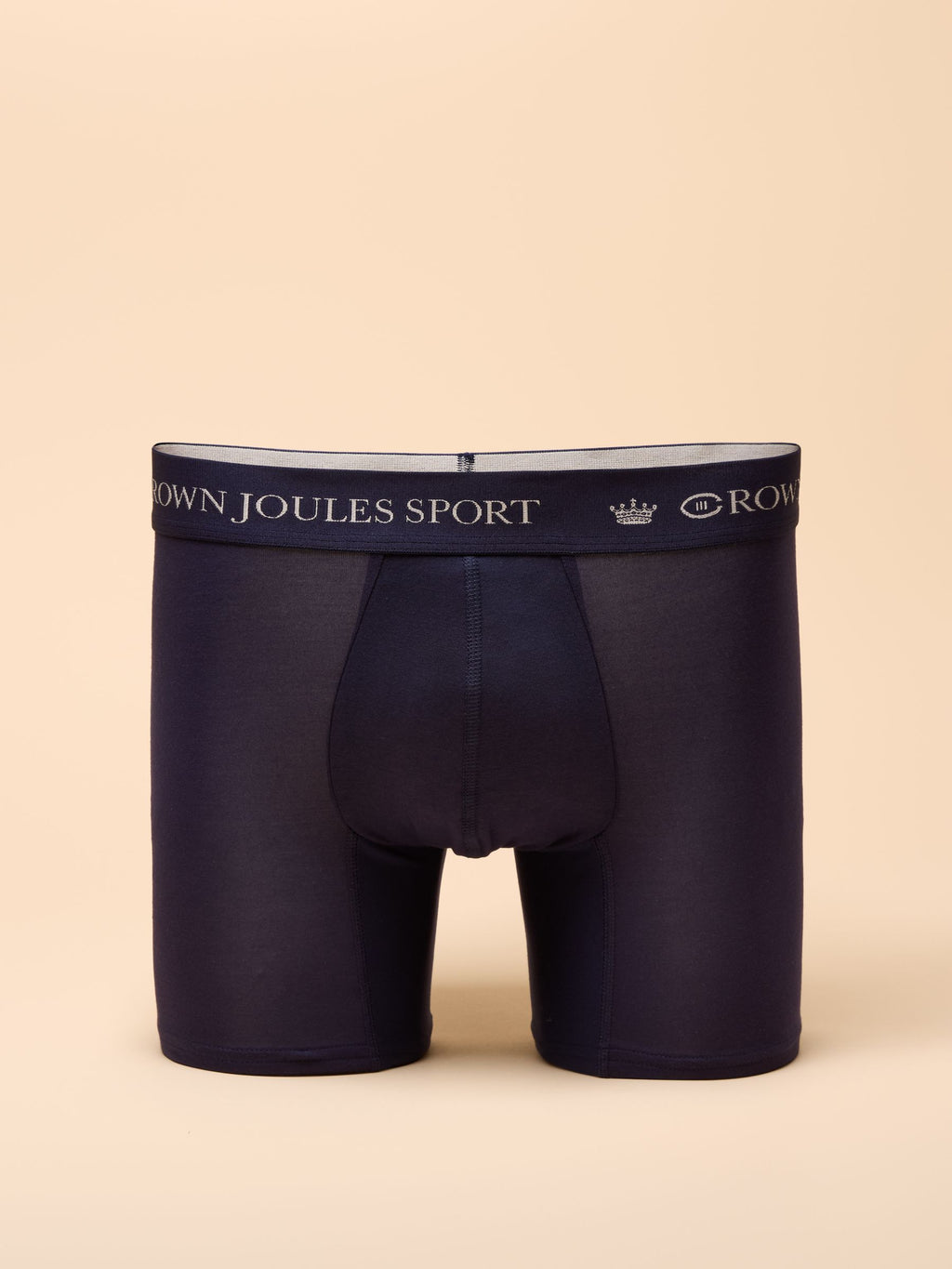 Navy blue boxer briefs with brand logo on beige background