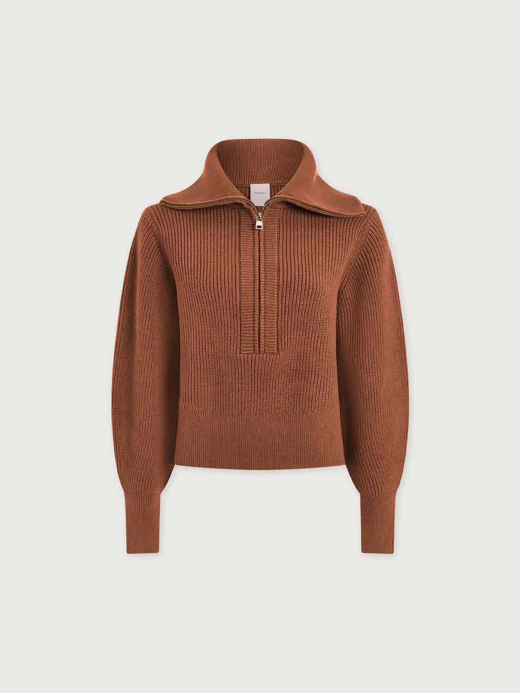Brown ribbed sweater with a quarter zip on a light beige background
