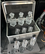 Set of crystal heads in a metal case with tools on a dark background
