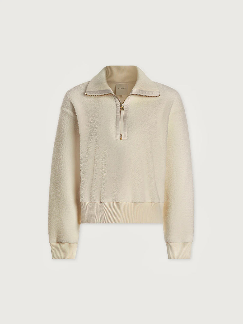 Beige sweater with a quarter zip on a light gray background