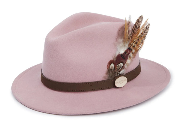 Pink fedora hat with a brown band and feathers on a white background