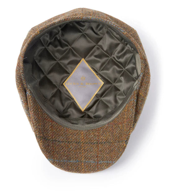 Brown checkered flat cap with quilted interior on a white background