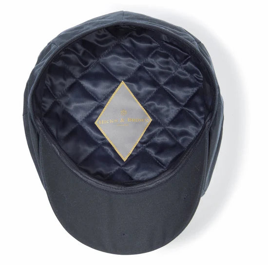 Navy blue cap with quilted interior and visible brand logo on a white background