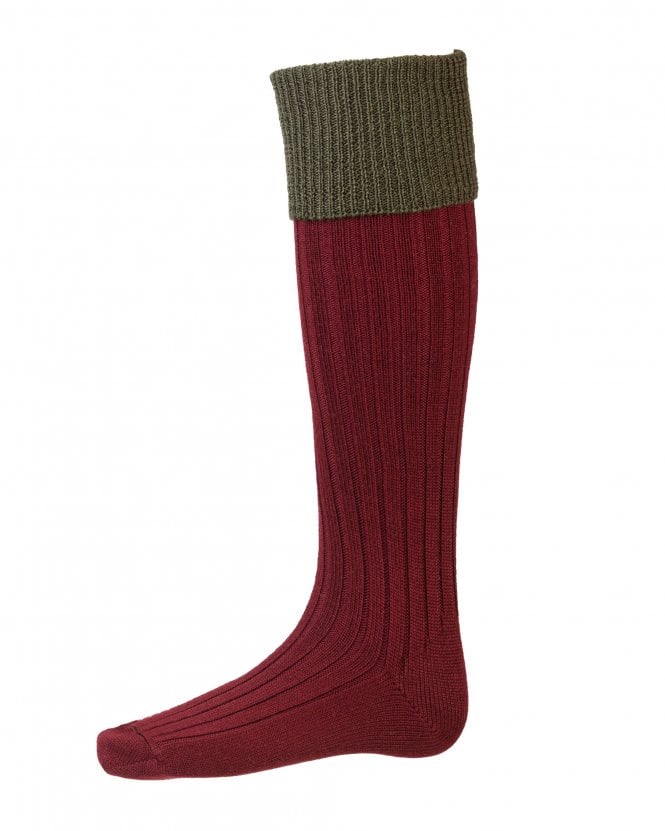 Red knee-high sock with green top on a white background