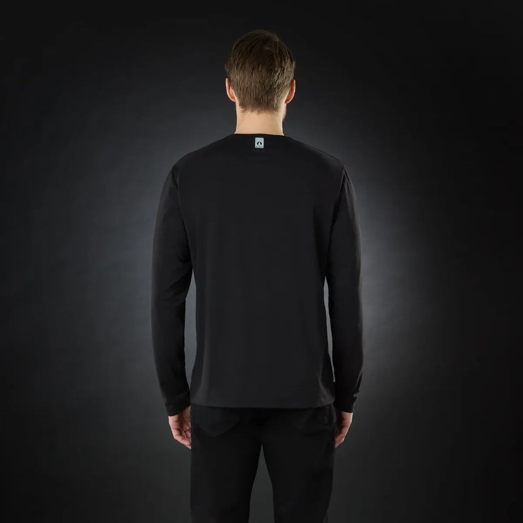 A man wearing a black long-sleeve t-shirt on a black background