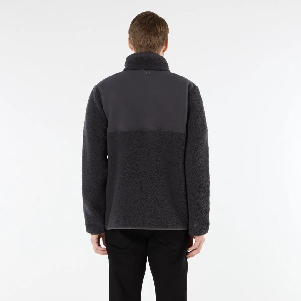 Person wearing a dark gray fleece jacket on a white background