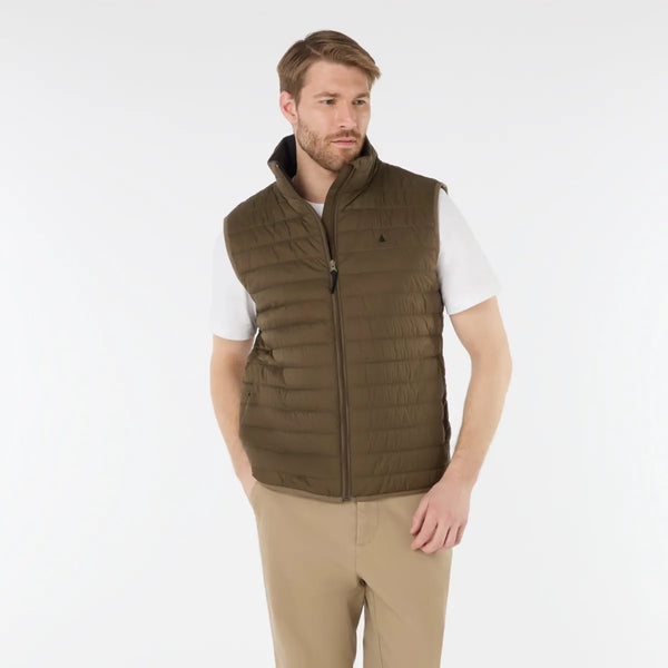 Man wearing a green vest with a small logo on a white background