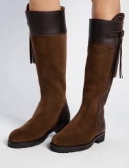 Brown knee-high boots with black accents on a white background