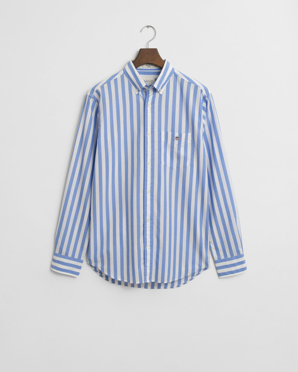 Blue and white striped shirt on a hanger against a light gray background