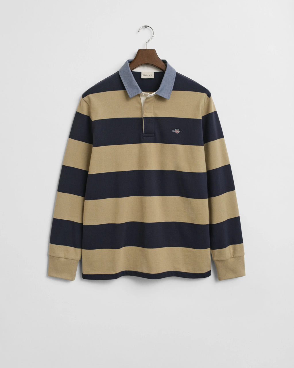Beige and navy striped long-sleeve shirt on a hanger against a white background