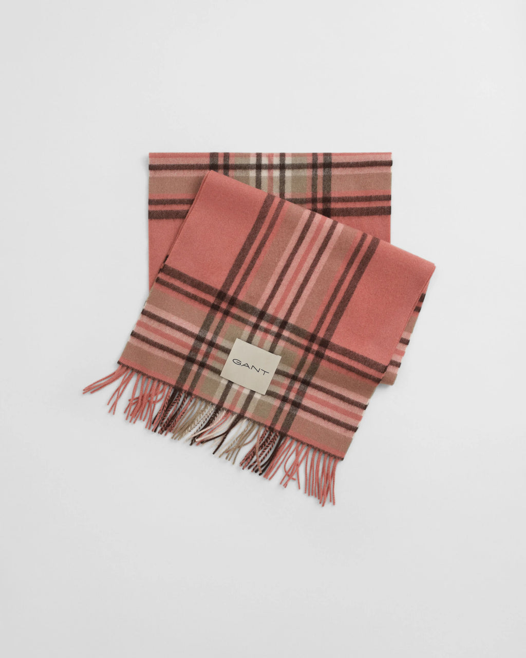 Plaid scarf with fringes on a light gray background