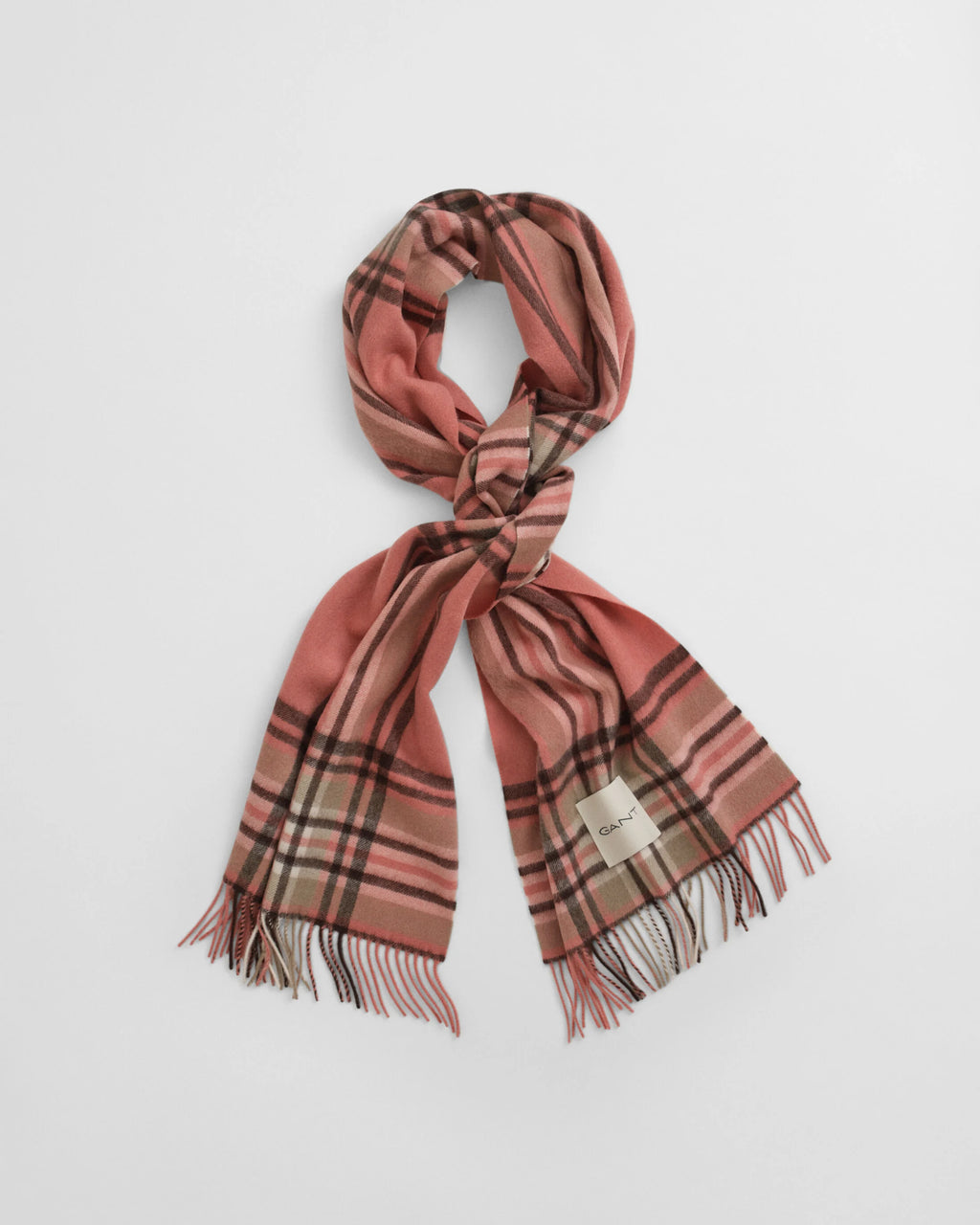 Plaid scarf with fringes on a light gray background