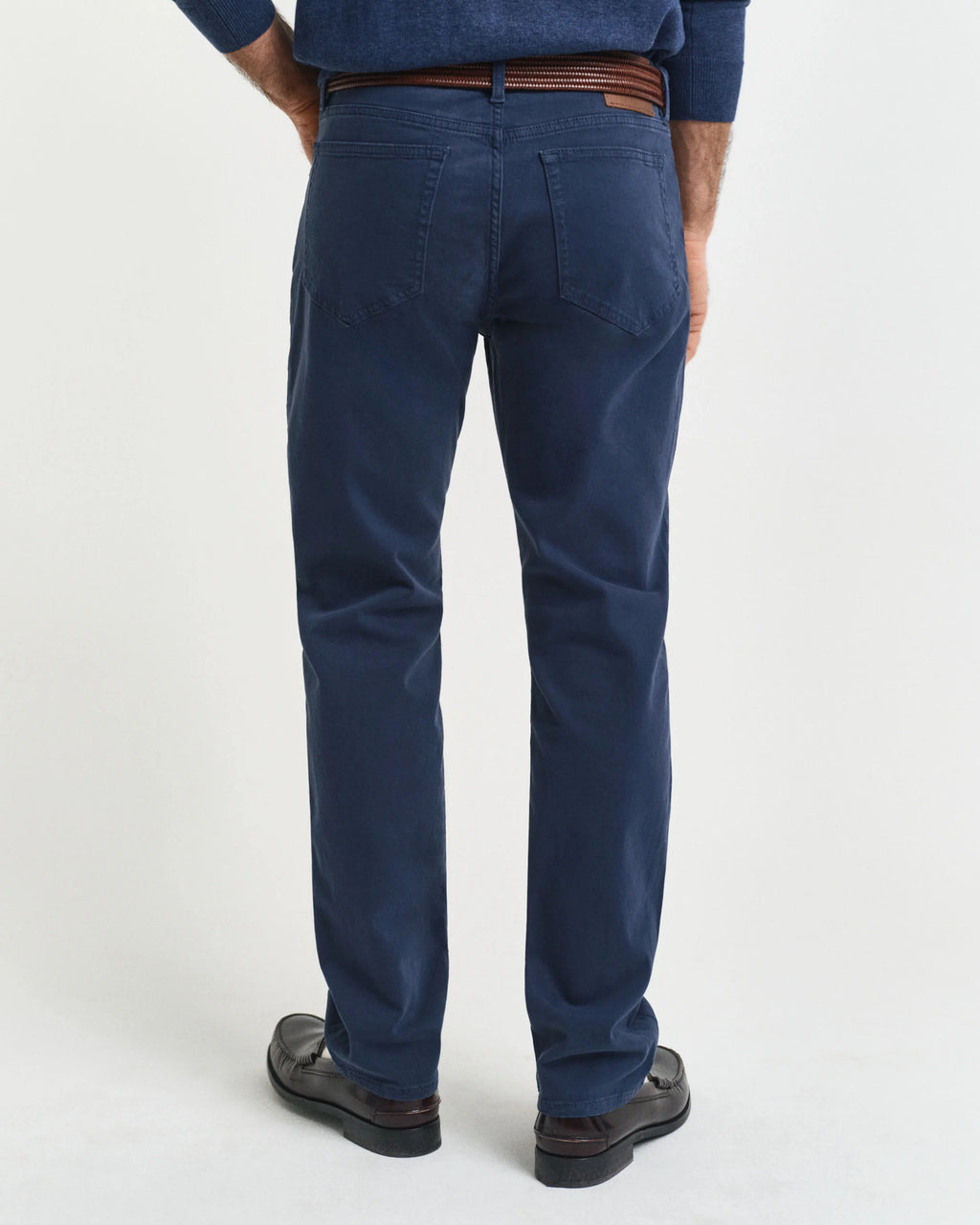 Person wearing blue pants on a white background