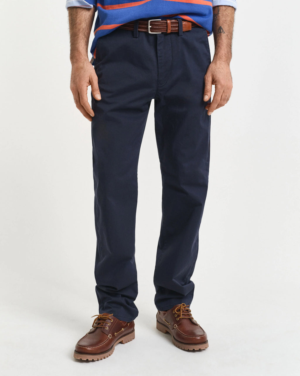 Navy pants worn by a person on a white background