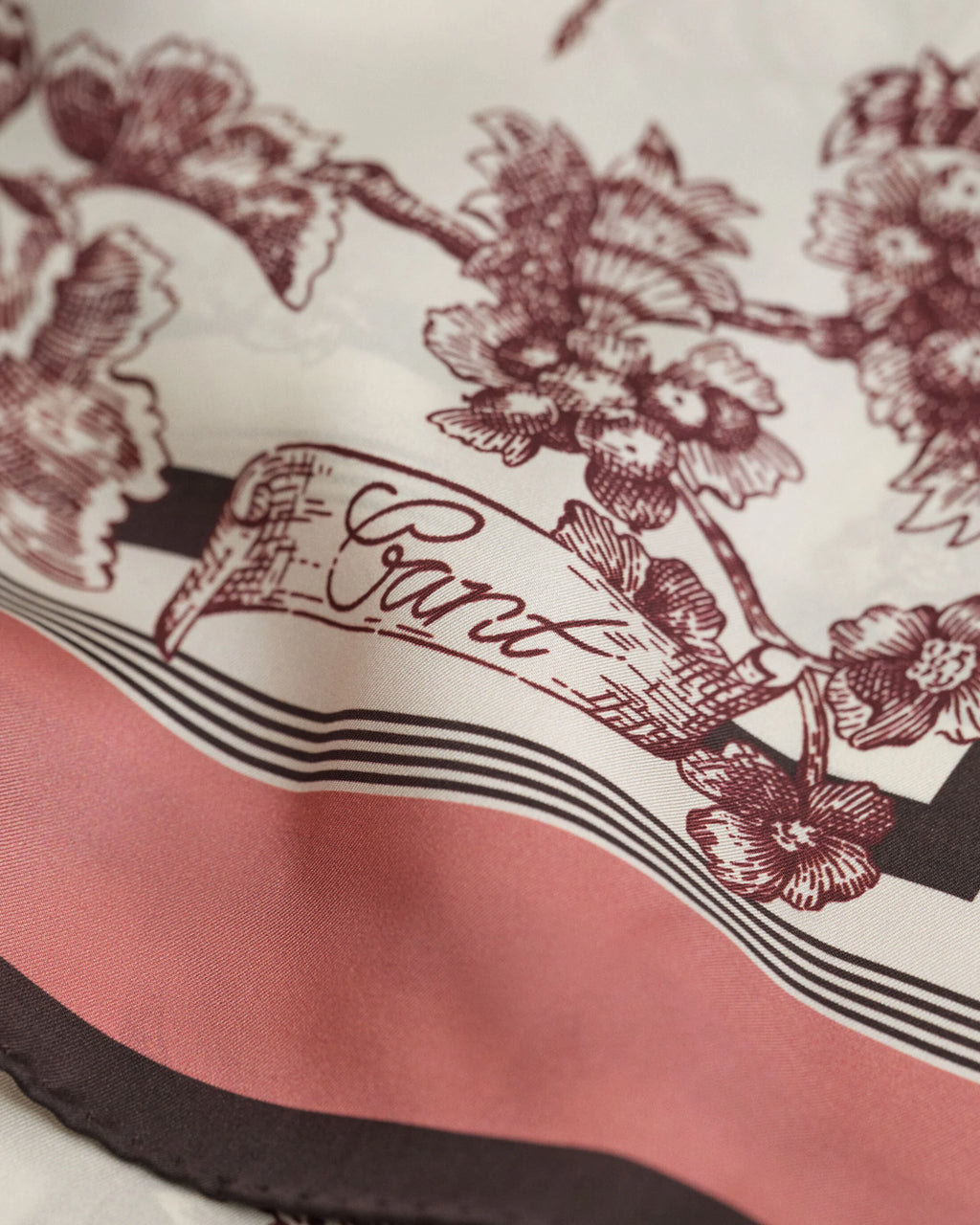 Close-up of a product with floral design and 'Gant' branding.