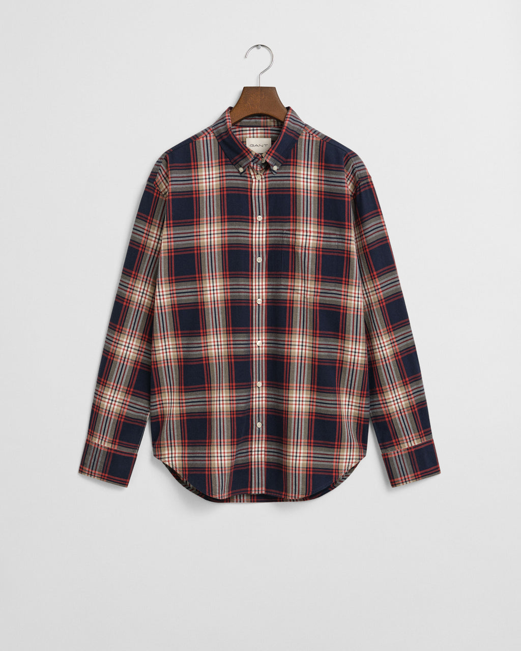 Plaid shirt on a hanger against a light gray background