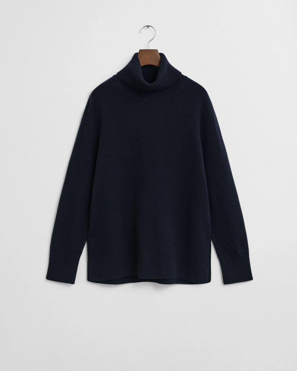 Black turtleneck sweater on a hanger against a white background