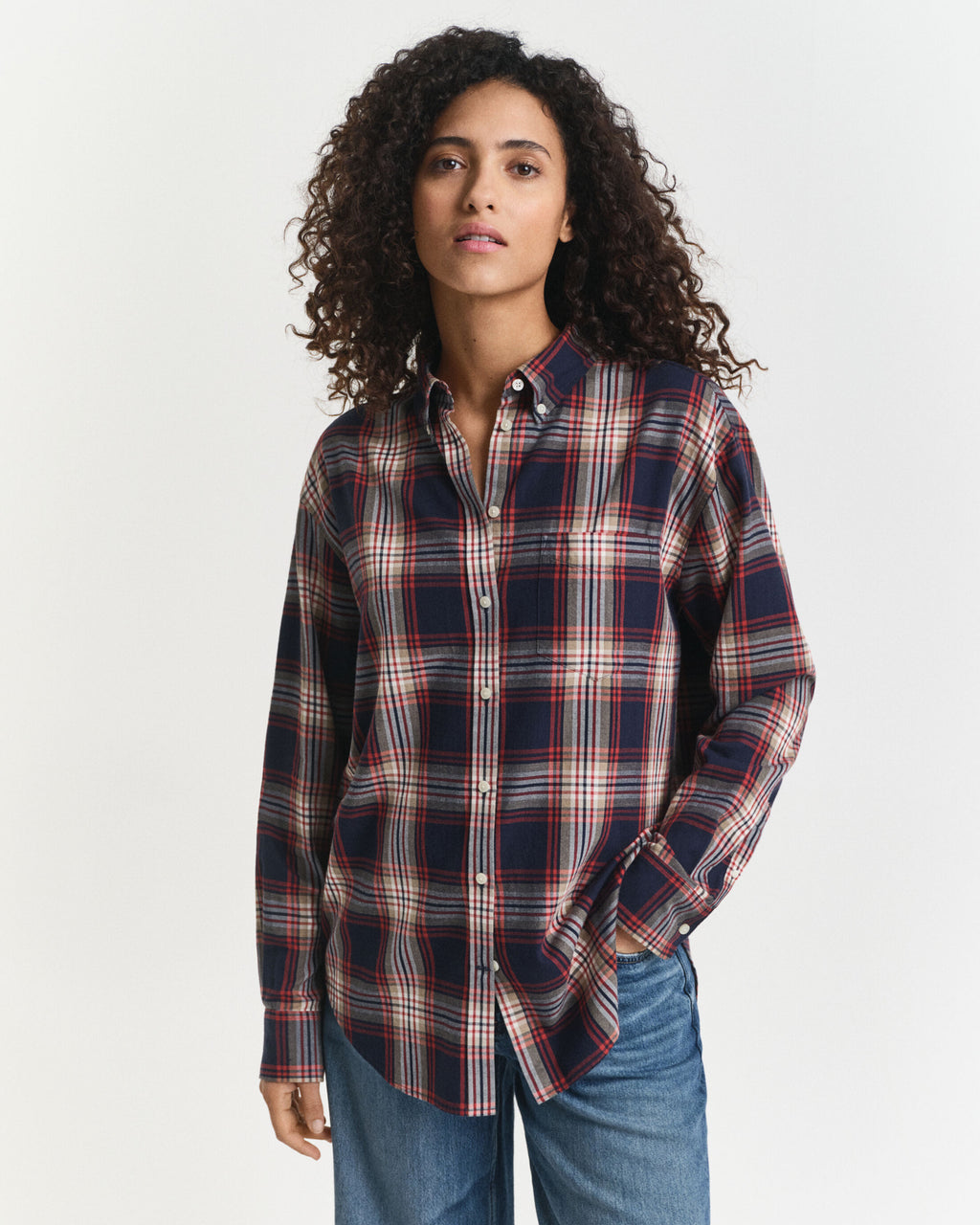 Woman wearing a plaid shirt and jeans on a white background