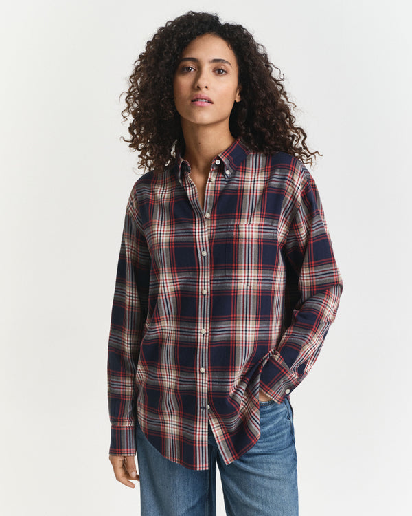 Woman wearing a plaid shirt and jeans on a white background