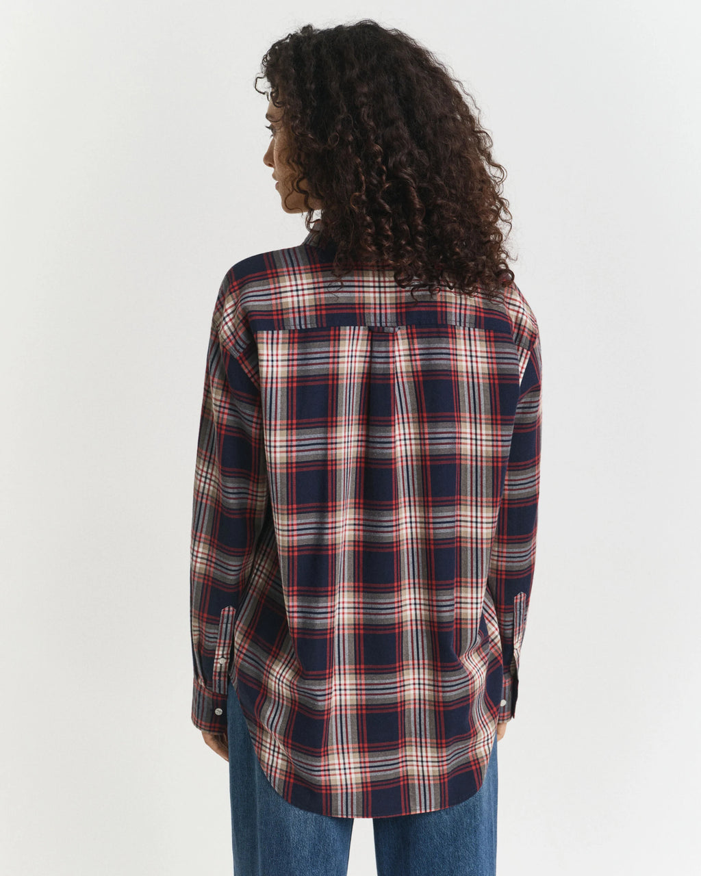 Person wearing a plaid shirt with a white background