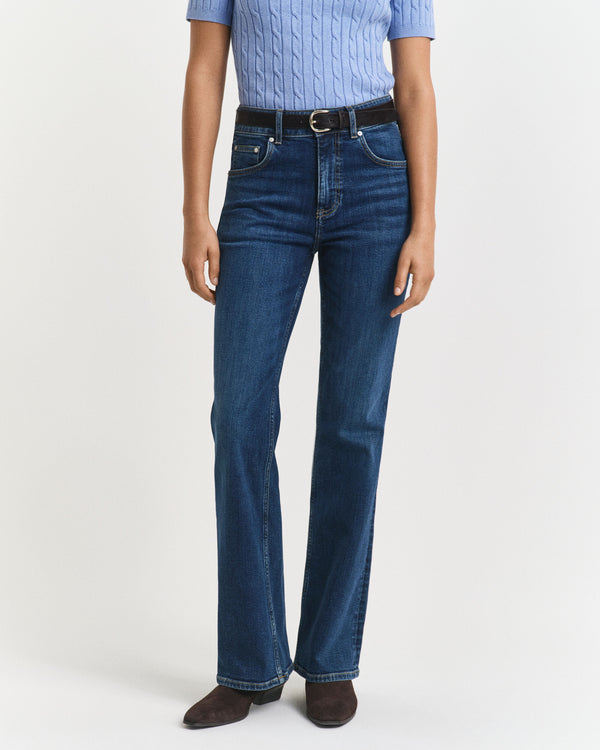 Person wearing blue jeans and a light blue shirt on a white background