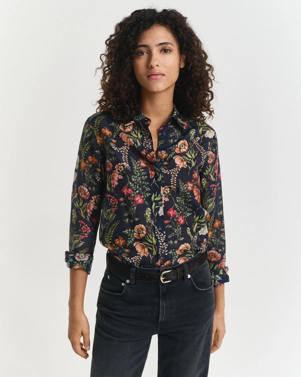 Woman wearing a floral patterned shirt on a white background