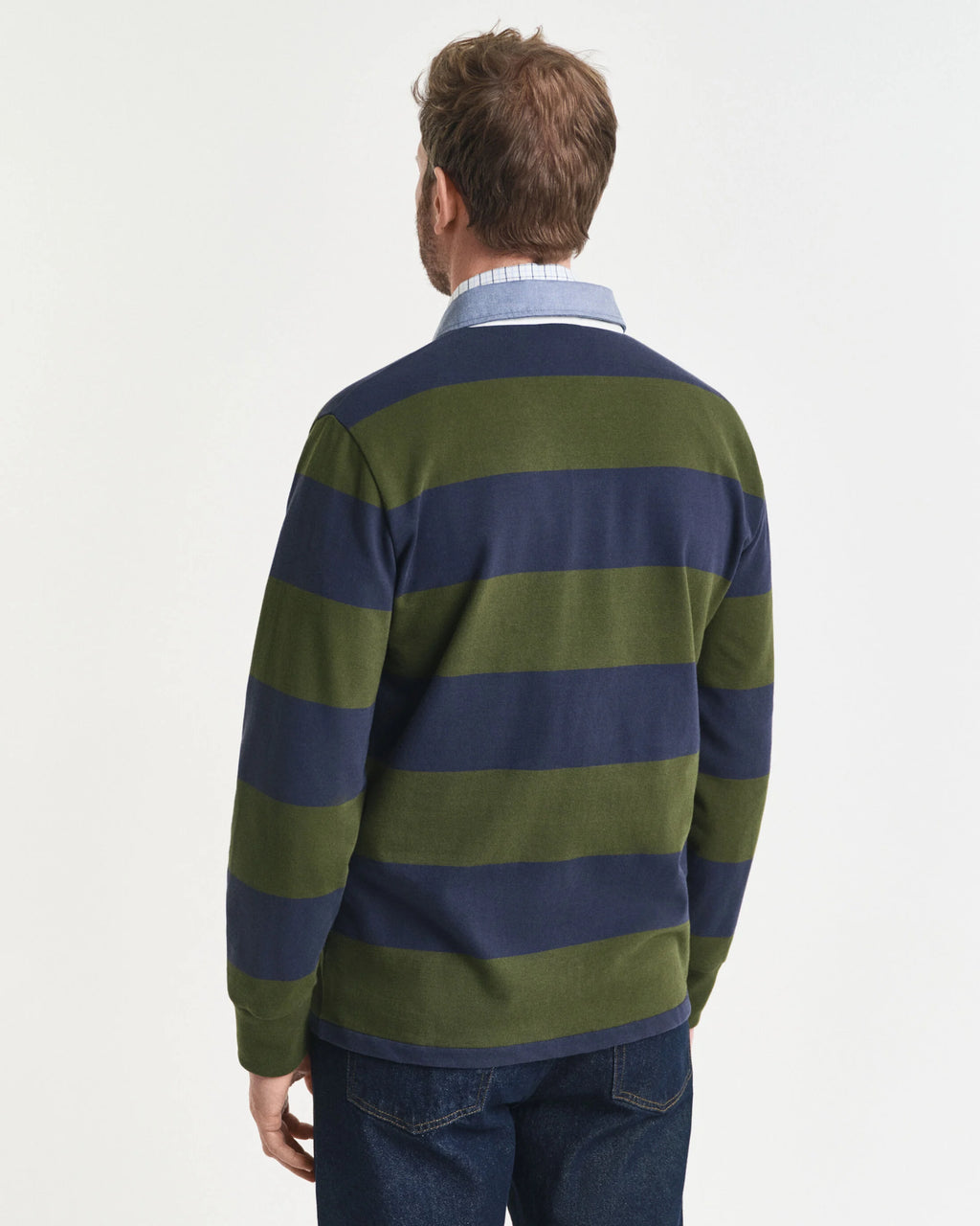 Man wearing a green and navy striped sweater on a white background