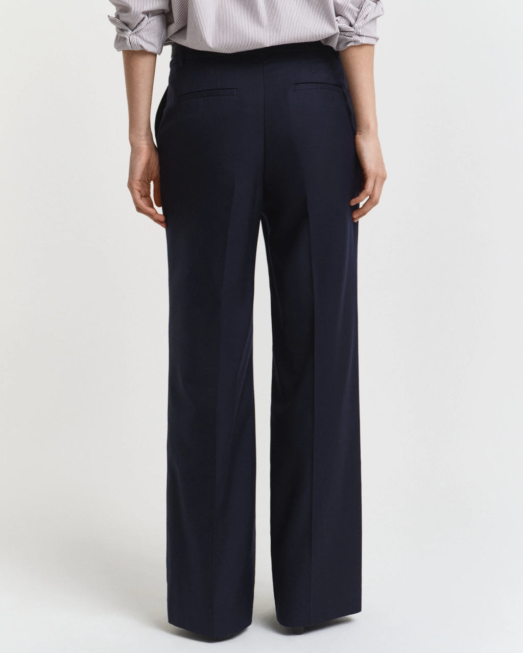 Navy wide-leg pants worn by a person on a white background