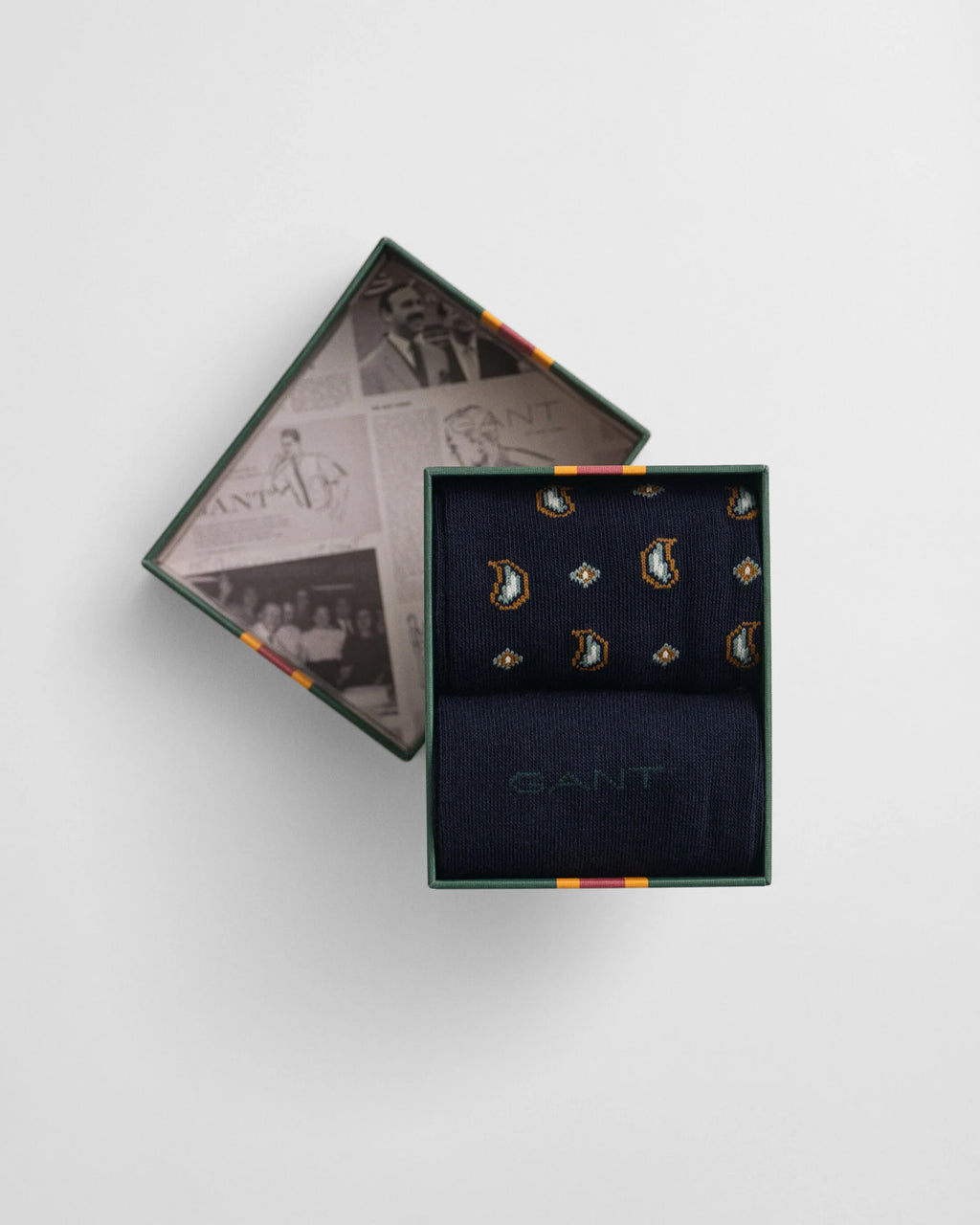 Set of earrings in a Gant branded box on a light gray background