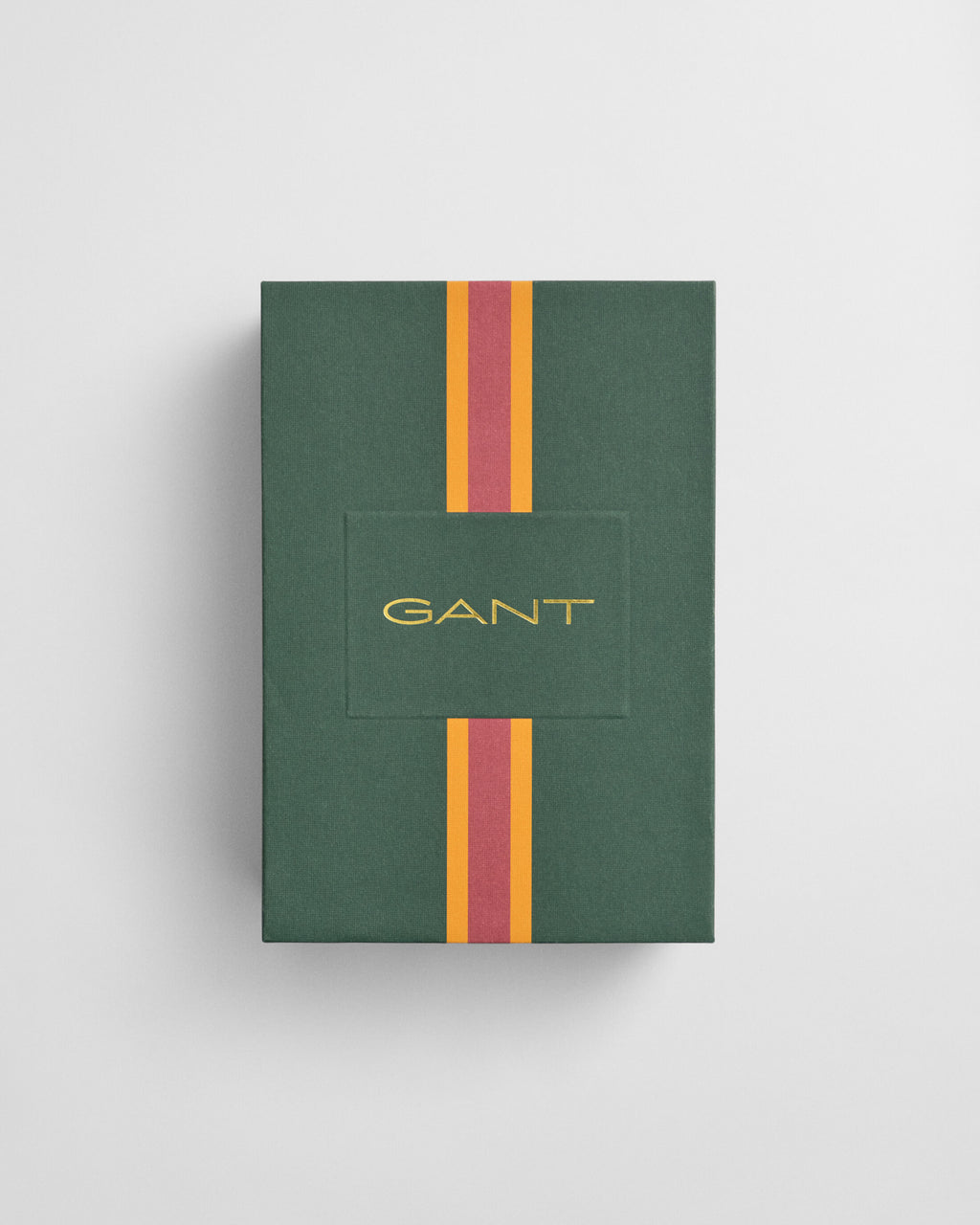 Green Gant box with red and yellow stripes on a light gray background
